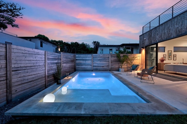 2800 Del Curto Rd Unit 9, Austin, TX 78704 - pool at dusk featuring a fenced backyard and a patio area