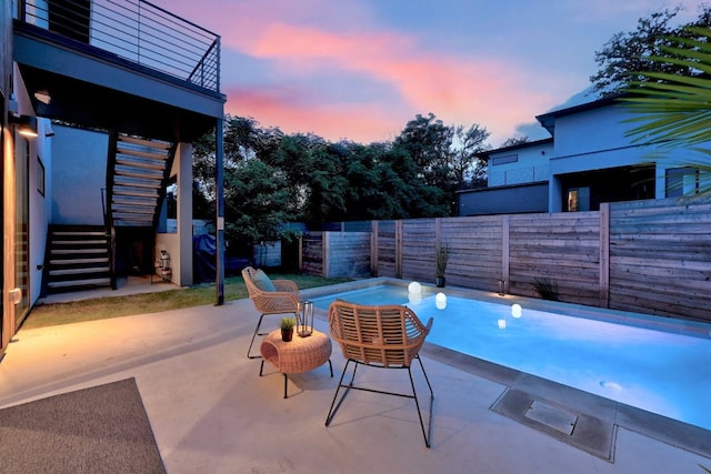 2800 Del Curto Rd Unit 9, Austin, TX 78704 - pool at dusk with a fenced backyard, stairway, and a patio area