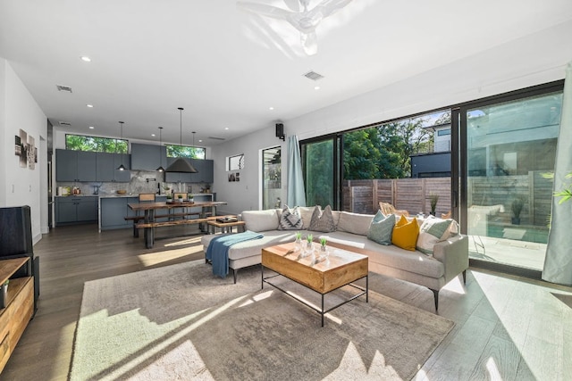 living area featuring plenty of natural light, recessed lighting, wood finished floors, and a ceiling fan