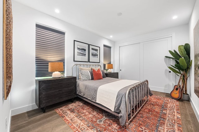bedroom featuring recessed lighting, baseboards, a closet, and wood finished floors