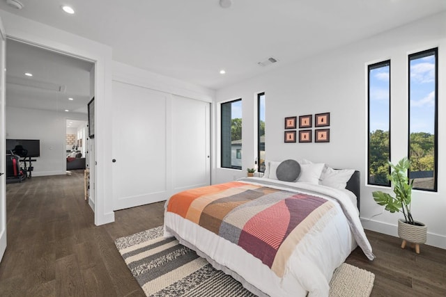 bedroom featuring recessed lighting, wood finished floors, a closet, and baseboards