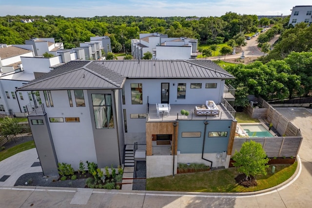 2800 Del Curto Rd Unit 9, Austin, TX 78704 - view of front facade with stucco siding, metal roof, a balcony, a standing seam roof, and stairway