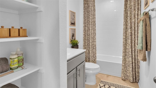 194 Inks Ln, Kyle, TX 78640 - full bath featuring toilet, wood finished floors, vanity, and shower / bathtub combination with curtain