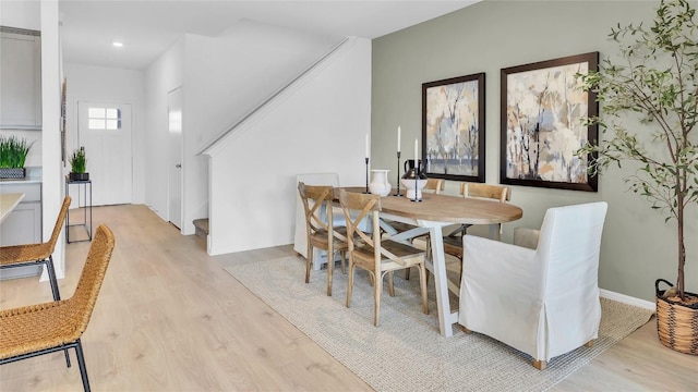 194 Inks Ln, Kyle, TX 78640 - dining room featuring light wood-style flooring, recessed lighting, and stairway