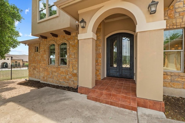 8293 Lime Creek Rd, Volente, TX 78641 - property entrance with stone siding, french doors, and stucco siding