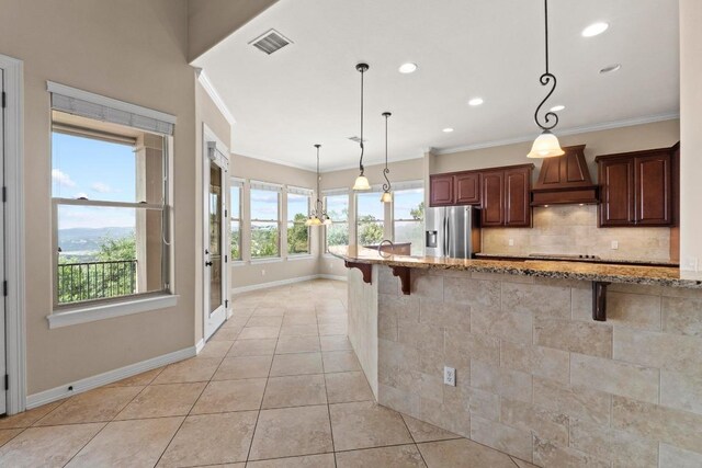 kitchen featuring stainless steel refrigerator with ice dispenser, custom range hood, baseboards, a kitchen breakfast bar, and ornamental molding