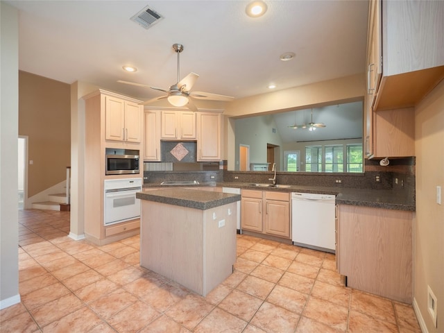 11029 Ballybunion Pl, Austin, TX 78747 - kitchen featuring white appliances, ceiling fan, tasteful backsplash, a center island, and recessed lighting
