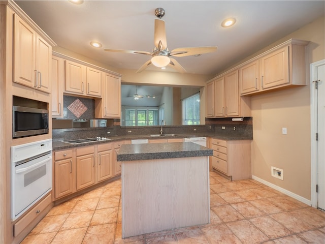 11029 Ballybunion Pl, Austin, TX 78747 - kitchen with white appliances, tasteful backsplash, a sink, dark countertops, and recessed lighting