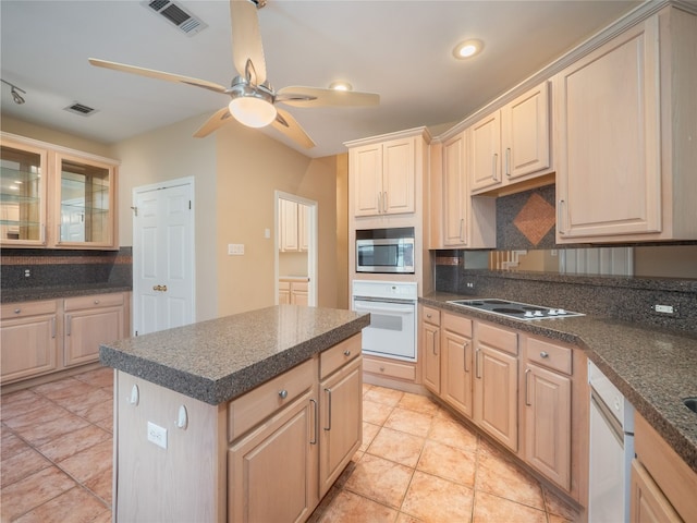 11029 Ballybunion Pl, Austin, TX 78747 - kitchen with white appliances, light brown cabinetry, dark countertops, and recessed lighting