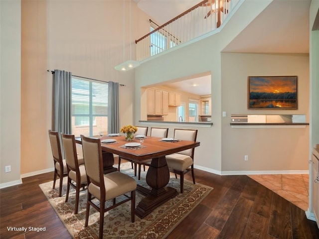 11029 Ballybunion Pl, Austin, TX 78747 - dining space featuring a high ceiling, wood finished floors, and baseboards