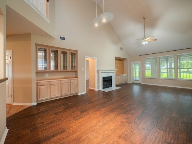 11029 Ballybunion Pl, Austin, TX 78747 - unfurnished living room with high vaulted ceiling, dark wood-style flooring, a ceiling fan, baseboards, and a fireplace