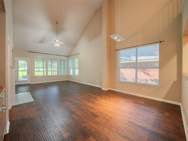 11029 Ballybunion Pl, Austin, TX 78747 - unfurnished living room with high vaulted ceiling, dark wood finished floors, ceiling fan, and baseboards