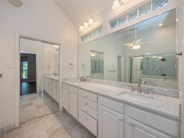 11029 Ballybunion Pl, Austin, TX 78747 - full bath featuring a shower with door, a ceiling fan, high vaulted ceiling, and double vanity