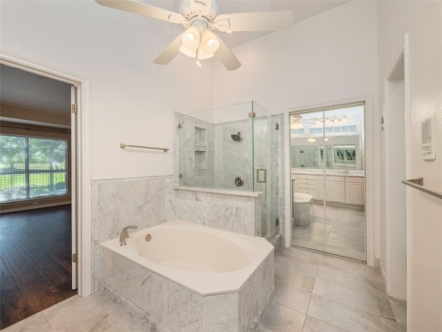 11029 Ballybunion Pl, Austin, TX 78747 - full bathroom featuring a marble finish shower, a garden tub, a ceiling fan, vanity, and tile patterned flooring