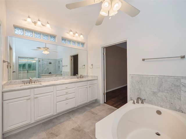 11029 Ballybunion Pl, Austin, TX 78747 - bathroom with ceiling fan, a stall shower, high vaulted ceiling, double vanity, and a bath