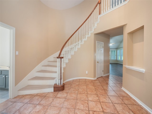 11029 Ballybunion Pl, Austin, TX 78747 - staircase with a towering ceiling and baseboards
