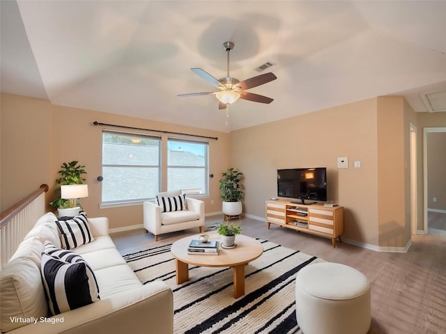 11029 Ballybunion Pl, Austin, TX 78747 - living room with lofted ceiling, ceiling fan, light wood finished floors, attic access, and baseboards