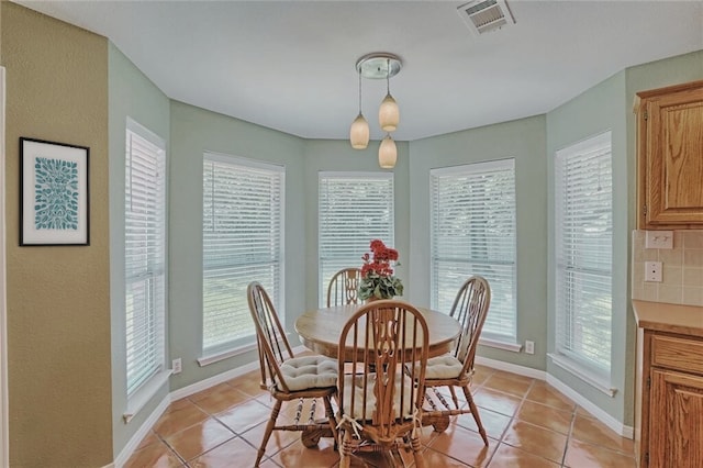 dining space featuring light tile patterned floors and baseboards