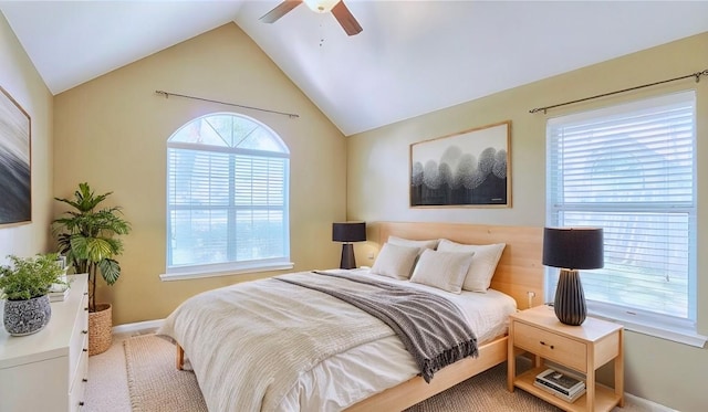 carpeted bedroom with vaulted ceiling, baseboards, and ceiling fan