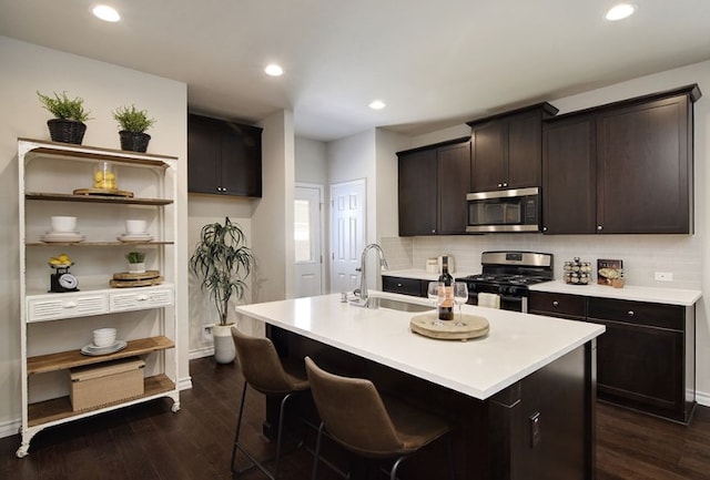 532 Emory Crossing Blvd, Hutto, TX 78634 - kitchen with stainless steel microwave, gas range oven, a sink, backsplash, and recessed lighting