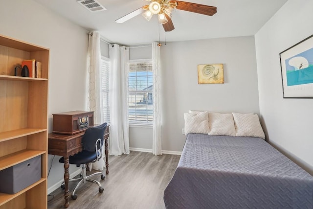 210 Salt Creek Ln, Georgetown, TX 78633 - bedroom with wood finished floors, baseboards, and a ceiling fan