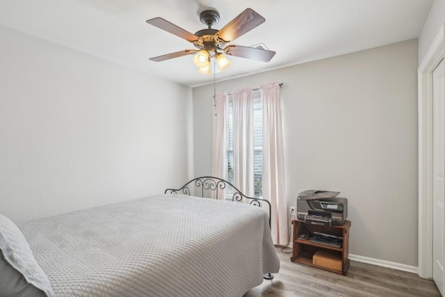 210 Salt Creek Ln, Georgetown, TX 78633 - bedroom with wood finished floors, a ceiling fan, and baseboards