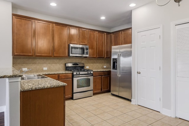 14815 Avery Ranch Blvd Unit 3401, Austin, TX 78717 - kitchen with stainless steel appliances, backsplash, recessed lighting, light tile patterned flooring, and brown cabinets