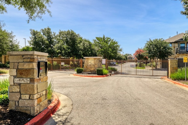 14815 Avery Ranch Blvd Unit 3401, Austin, TX 78717 - view of asphalt street with curbs, a gate, and a gated entry