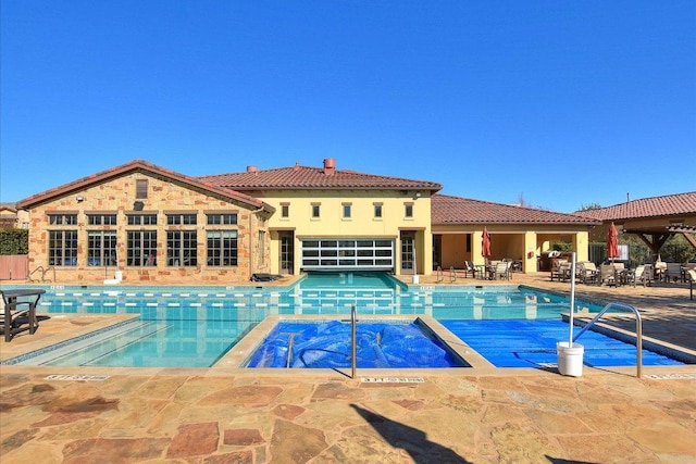 102 Bella Toscana Ave Unit 1306, Lakeway, TX 78734 - view of swimming pool featuring a patio and a pool with connected hot tub
