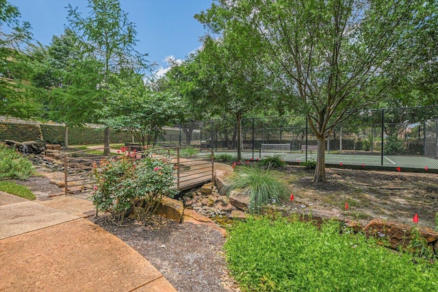 102 Bella Toscana Ave Unit 1306, Lakeway, TX 78734 - view of yard featuring a tennis court and fence