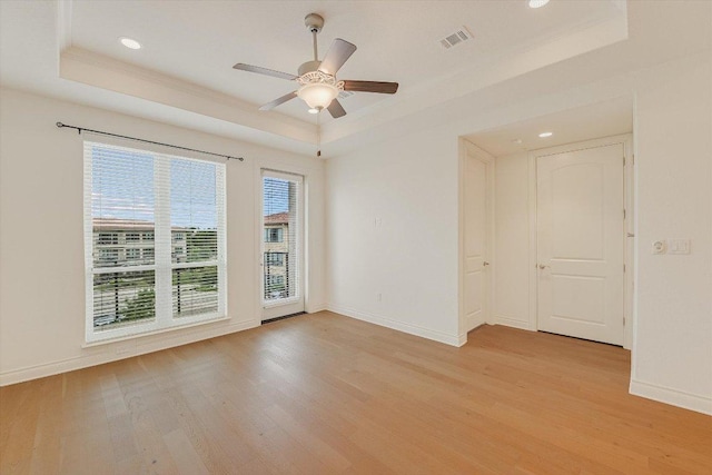 102 Bella Toscana Ave Unit 1306, Lakeway, TX 78734 - spare room with a tray ceiling, light wood-style flooring, baseboards, recessed lighting, and crown molding