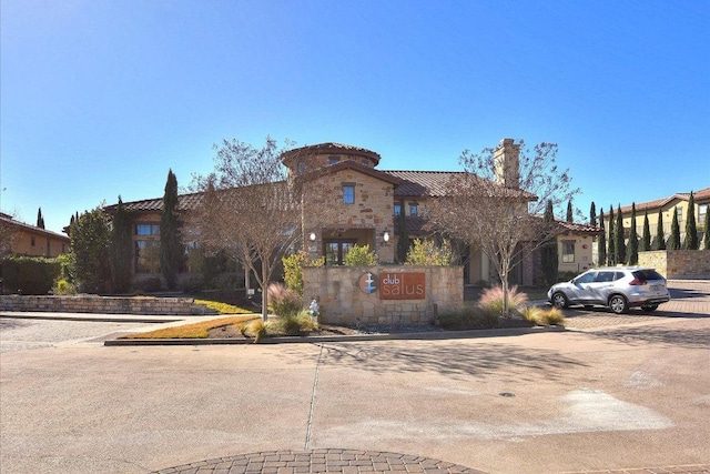 102 Bella Toscana Ave Unit 1306, Lakeway, TX 78734 - view of front of property with a chimney and stone siding