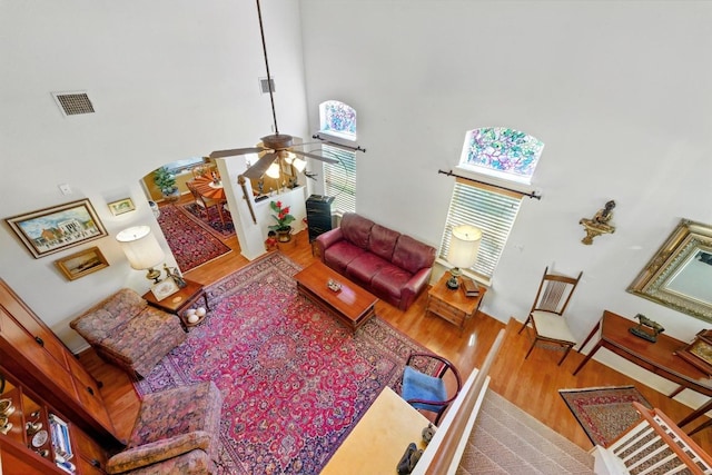 2111 Marcus Abrams Blvd, Austin, TX 78748 - living room with wood finished floors, a high ceiling, and ceiling fan