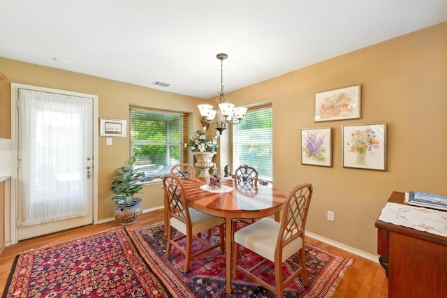 2111 Marcus Abrams Blvd, Austin, TX 78748 - dining space featuring a chandelier, light wood finished floors, and baseboards