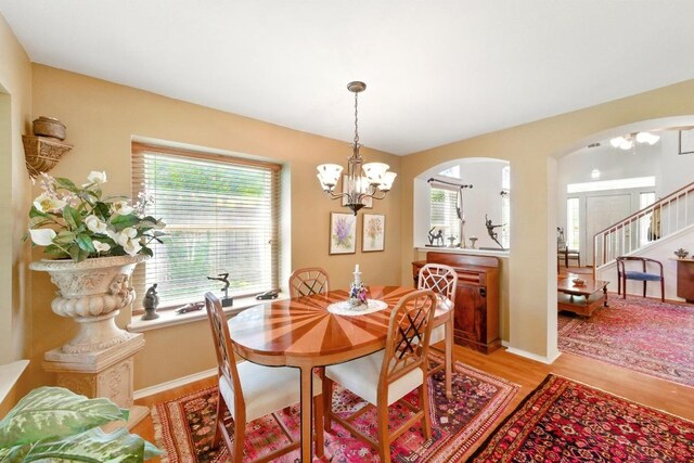 2111 Marcus Abrams Blvd, Austin, TX 78748 - dining space with a chandelier, light wood finished floors, plenty of natural light, and arched walkways