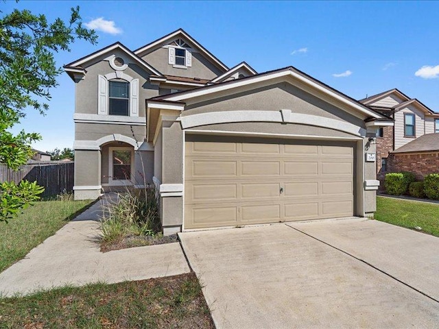 200 Karrie Dr, Kyle, TX 78640 - view of front of house featuring stucco siding, concrete driveway, and an attached garage