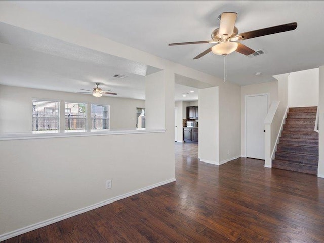 200 Karrie Dr, Kyle, TX 78640 - unfurnished living room featuring a ceiling fan, wood finished floors, and stairs