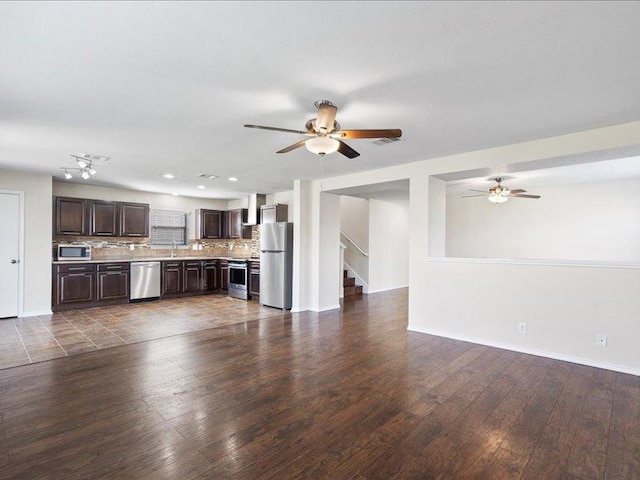 200 Karrie Dr, Kyle, TX 78640 - unfurnished living room with ceiling fan, dark wood finished floors, stairs, and recessed lighting