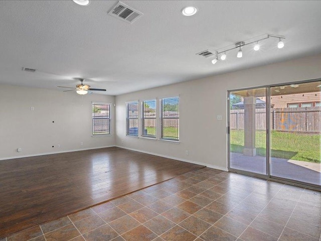 200 Karrie Dr, Kyle, TX 78640 - empty room with a ceiling fan and dark wood-style flooring