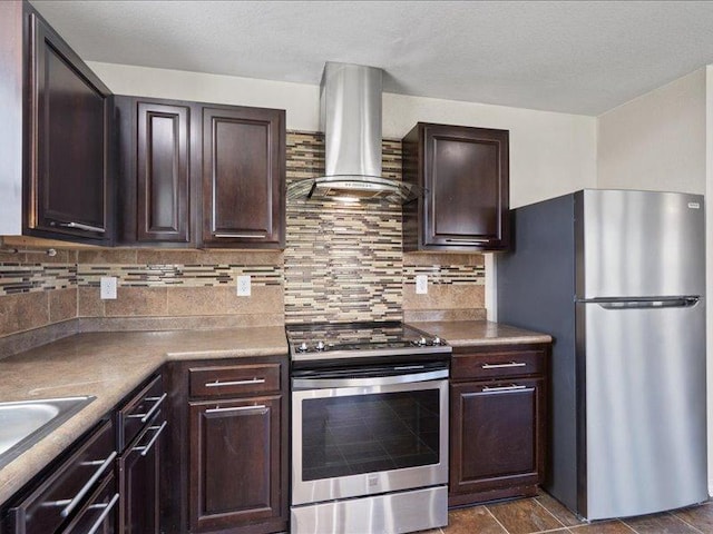 200 Karrie Dr, Kyle, TX 78640 - kitchen featuring stainless steel appliances, island range hood, dark brown cabinetry, and tasteful backsplash