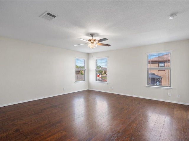 200 Karrie Dr, Kyle, TX 78640 - empty room featuring ceiling fan, dark wood finished floors, a smoke detector, and a textured ceiling