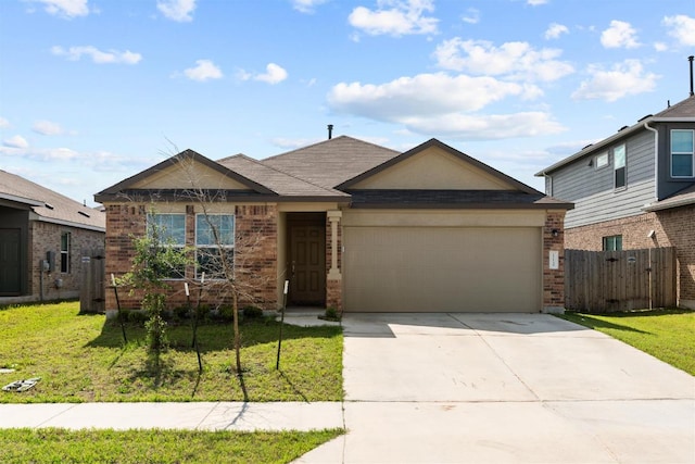 112 Montego St, Hutto, TX 78634 - view of front facade featuring brick siding, an attached garage, and concrete driveway