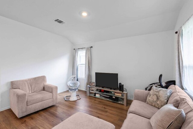 112 Montego St, Hutto, TX 78634 - living room with lofted ceiling, wood finished floors, and baseboards