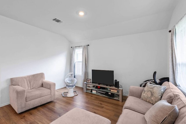 112 Montego St, Hutto, TX 78634 - living area featuring vaulted ceiling, wood finished floors, and baseboards