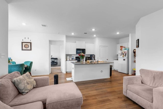 112 Montego St, Hutto, TX 78634 - living area with wood finished floors, recessed lighting, and baseboards