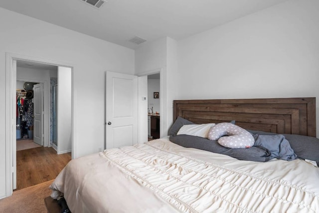 112 Montego St, Hutto, TX 78634 - bedroom featuring wood finished floors, baseboards, and a spacious closet