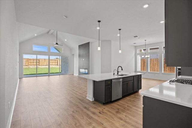 145 Lost Tree Dr, Buda, TX 78610 - kitchen featuring dishwasher, open floor plan, light countertops, light wood finished floors, and recessed lighting