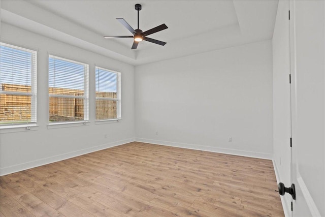 145 Lost Tree Dr, Buda, TX 78610 - unfurnished room with a raised ceiling, light wood-type flooring, a ceiling fan, and baseboards