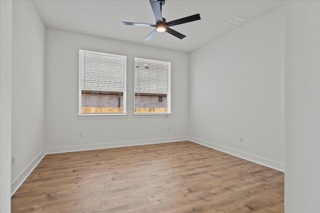 145 Lost Tree Dr, Buda, TX 78610 - empty room with wood finished floors, ceiling fan, and baseboards