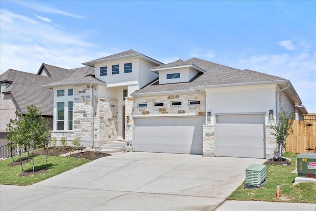 145 Lost Tree Dr, Buda, TX 78610 - view of front of home featuring stone siding, concrete driveway, stucco siding, and an attached garage